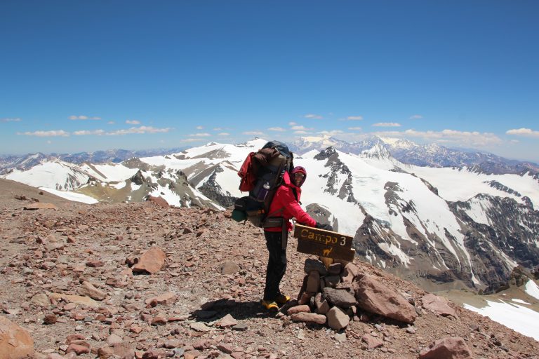 Person with sign at camp 3