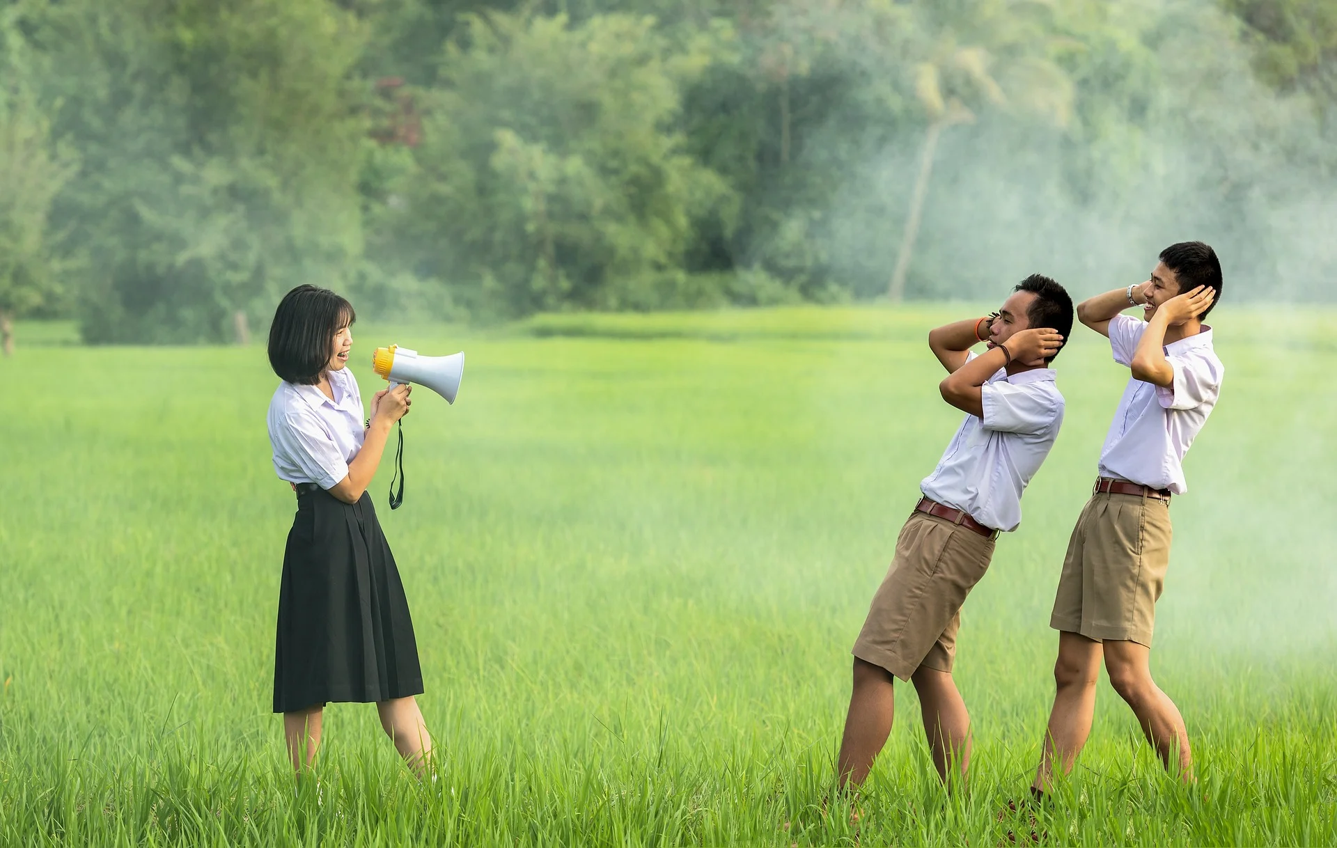 Woman yelling at men through megaphone