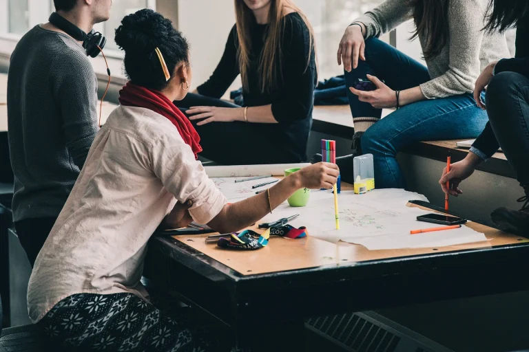 People talking around workplace table