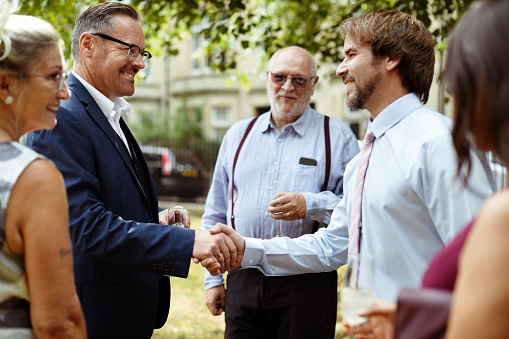 Men shaking hands at a party