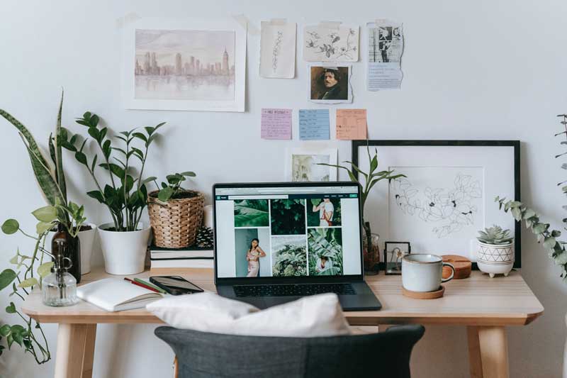 a proactive workspace with a computer, plants, planner and to do list