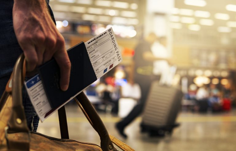 Man travelling with passport in hand